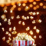 Pop-corn devant une enseigne lumineuse de cinéma — films X et VOD adulte illimitée